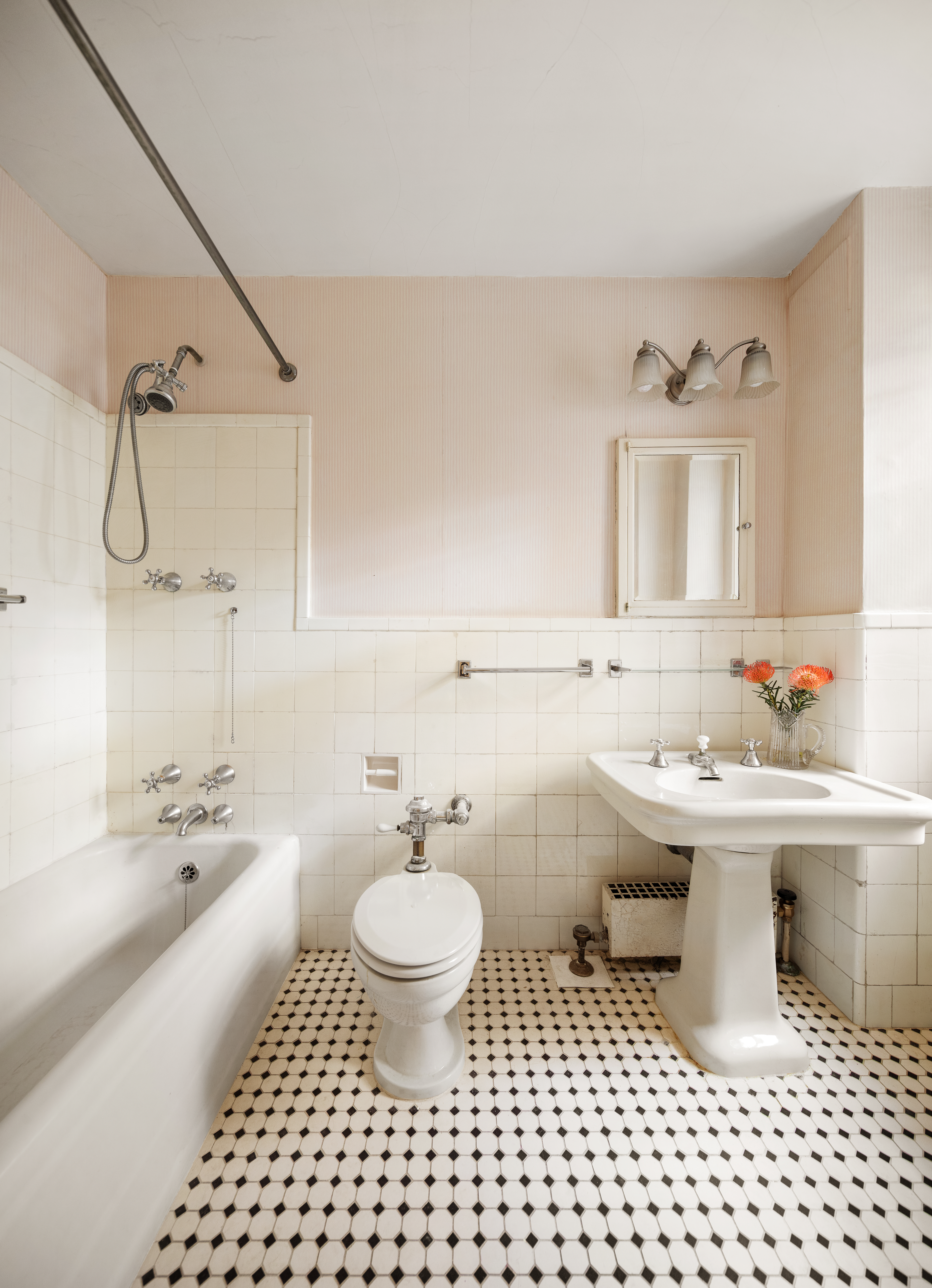 136 East 79th Street, Unit 4B Manhattan, NY 10075 - Photo 10 of 14 a bathroom with a sink toilet a mirror and vanity