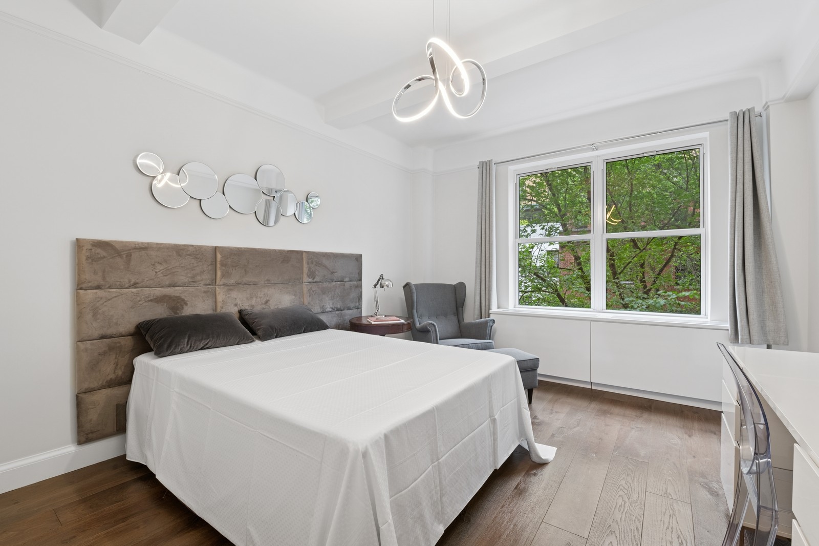 108 East 91st Street, Unit 4B Manhattan, NY 10128 - Photo 3 of 11 a bedroom with a bed and a large window