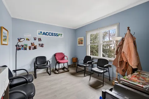 a view of a workspace with furniture and a window