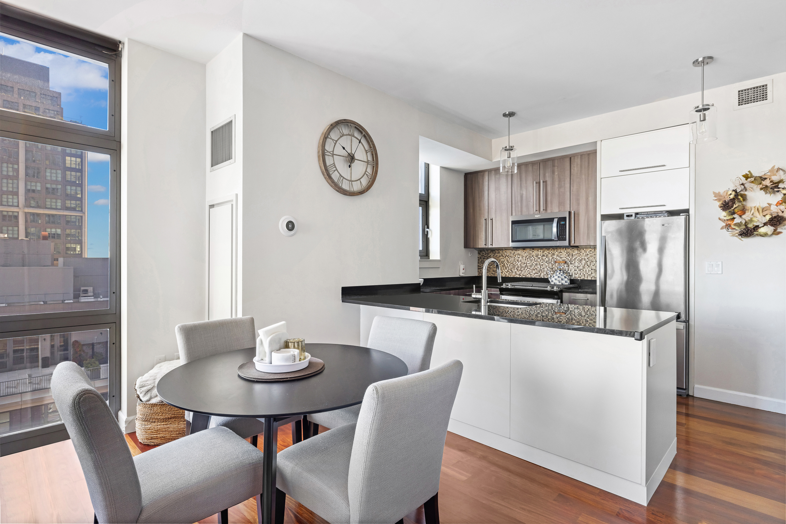 100 Jay Street, Unit 15C Brooklyn, NY 11201 - Photo 7 of 19 a kitchen with stainless steel appliances granite countertop a dining table chairs and a refrigerator