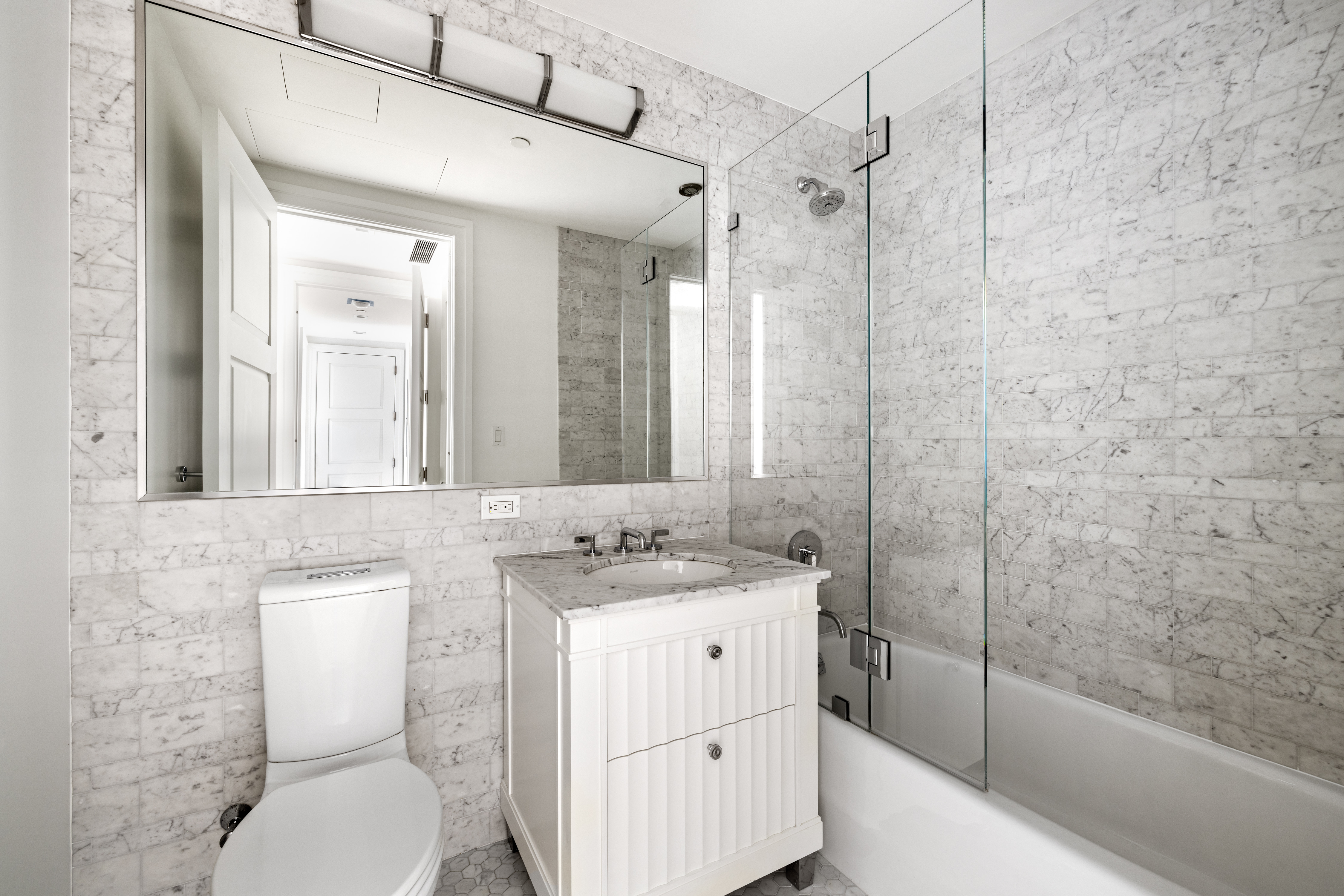 30 Park Place, Unit 43B Manhattan, NY 10007 - Photo 8 of 16 a bathroom with a sink toilet vanity and shower