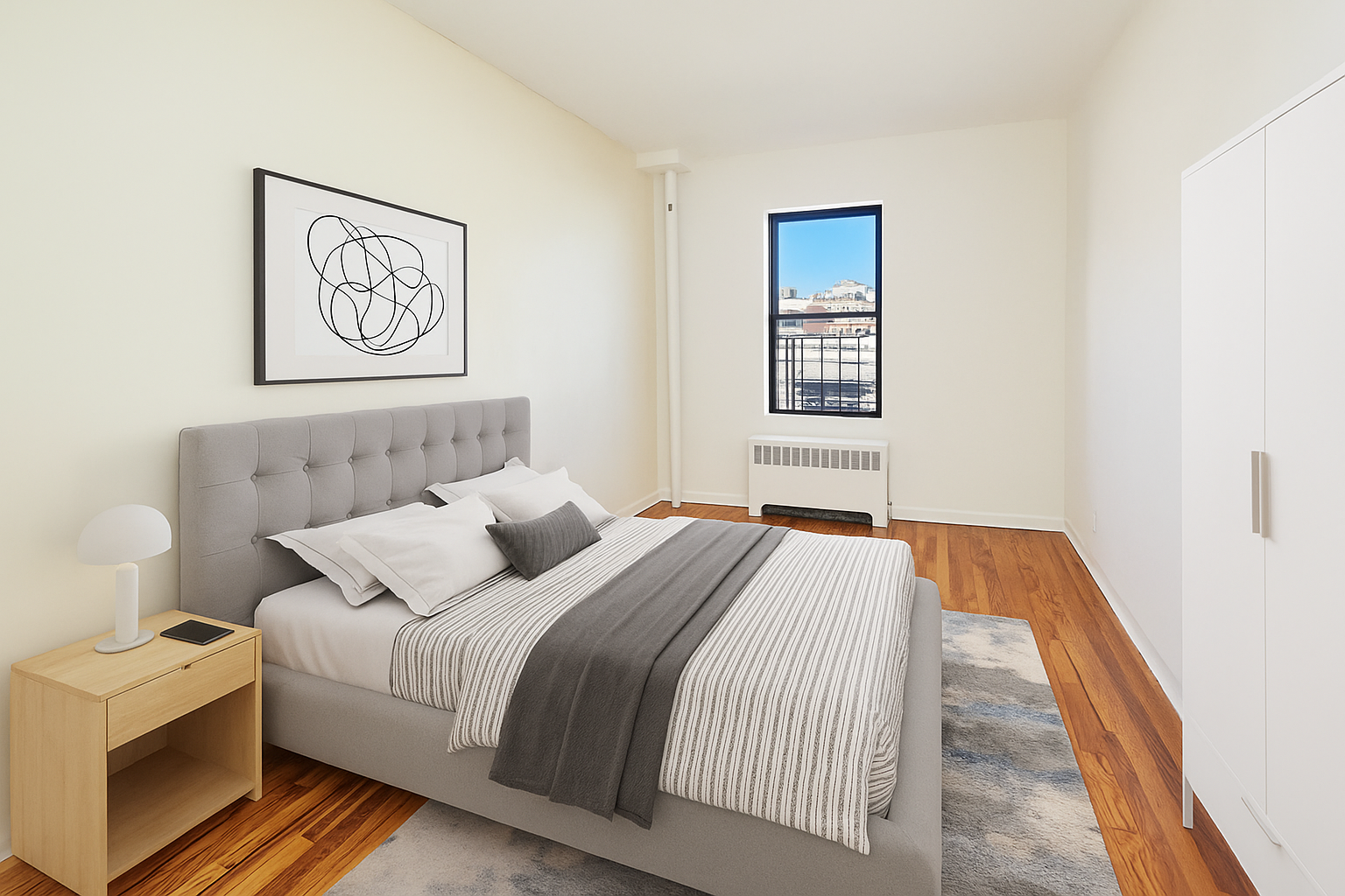 506 West 145th Street, Unit 4D Manhattan, NY 10031 - Photo 7 of 9 a bedroom with a bed and painting on the wall