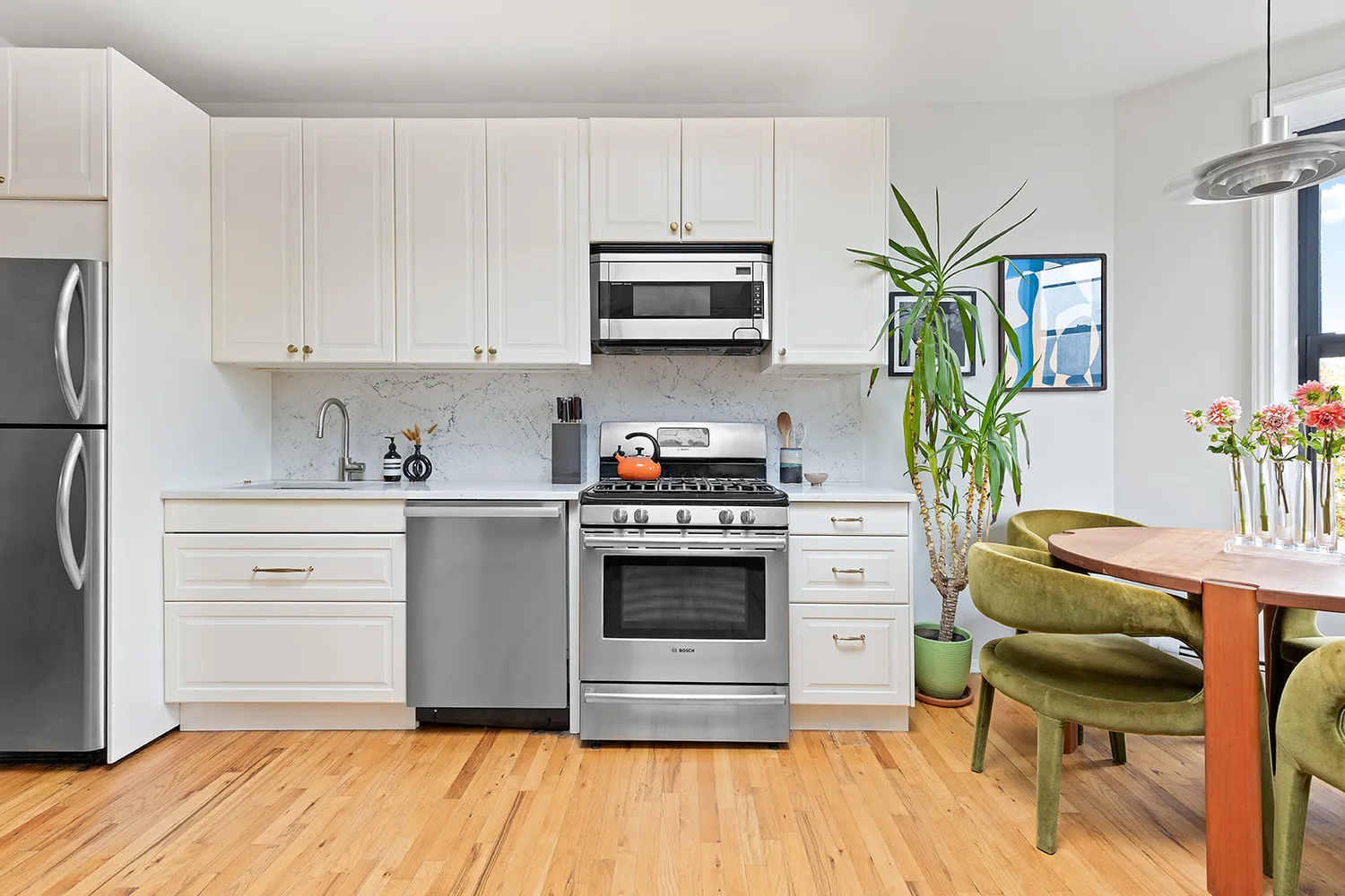 a kitchen with a white stove top oven and white appliances