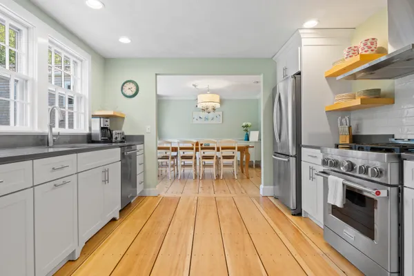 a kitchen with stainless steel appliances a stove a sink and a refrigerator