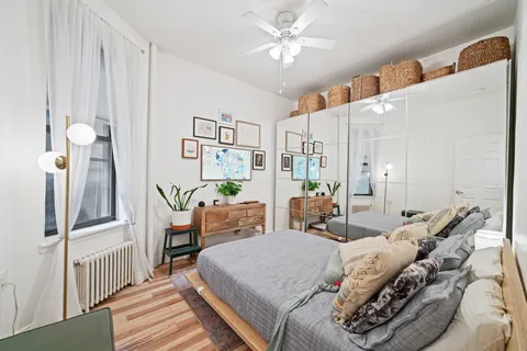 a bed room with a bed and a chandelier