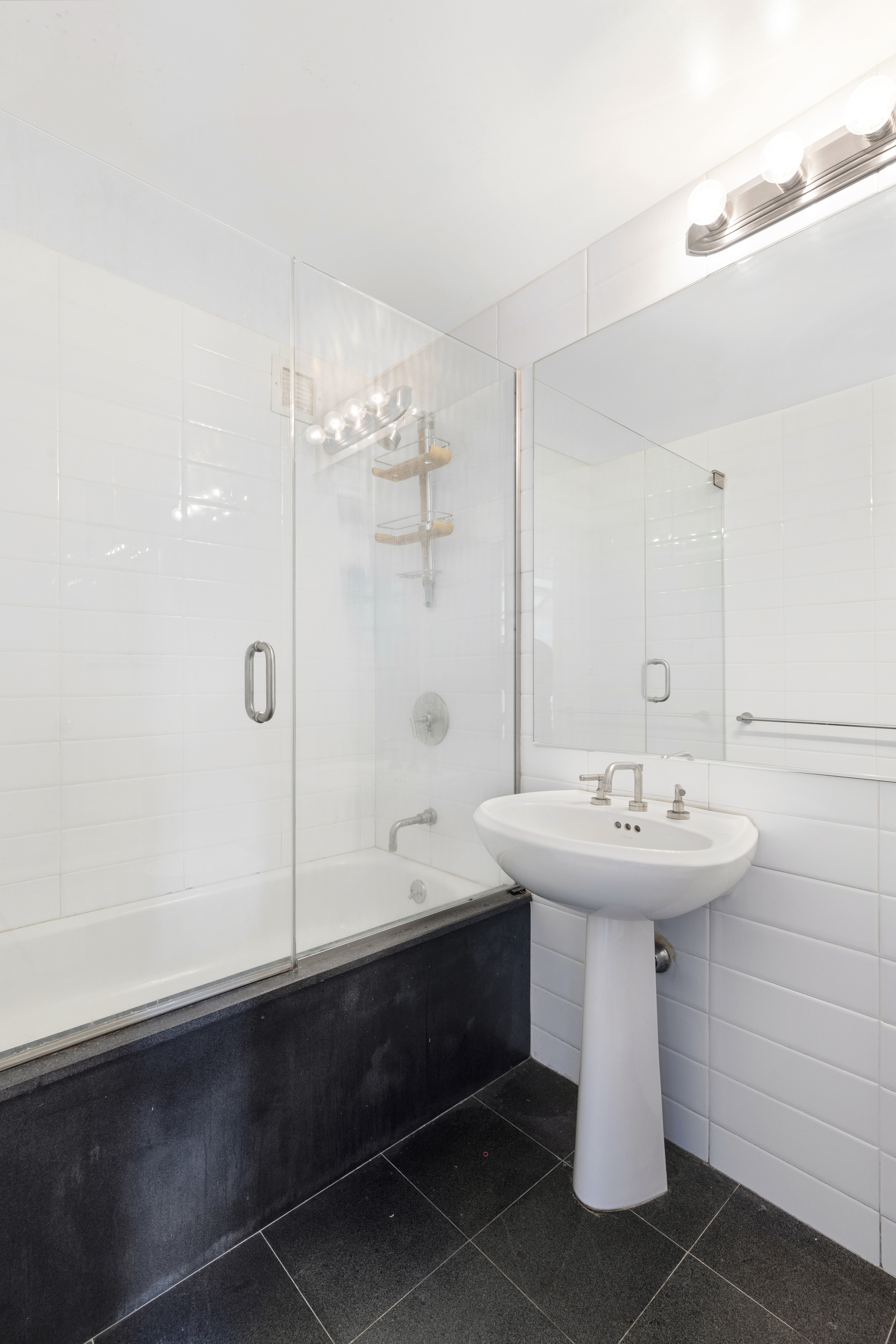 305 2nd Avenue, Unit 537 Manhattan, NY 10003 - Photo 9 of 11 a bathroom with a sink a toilet and shower