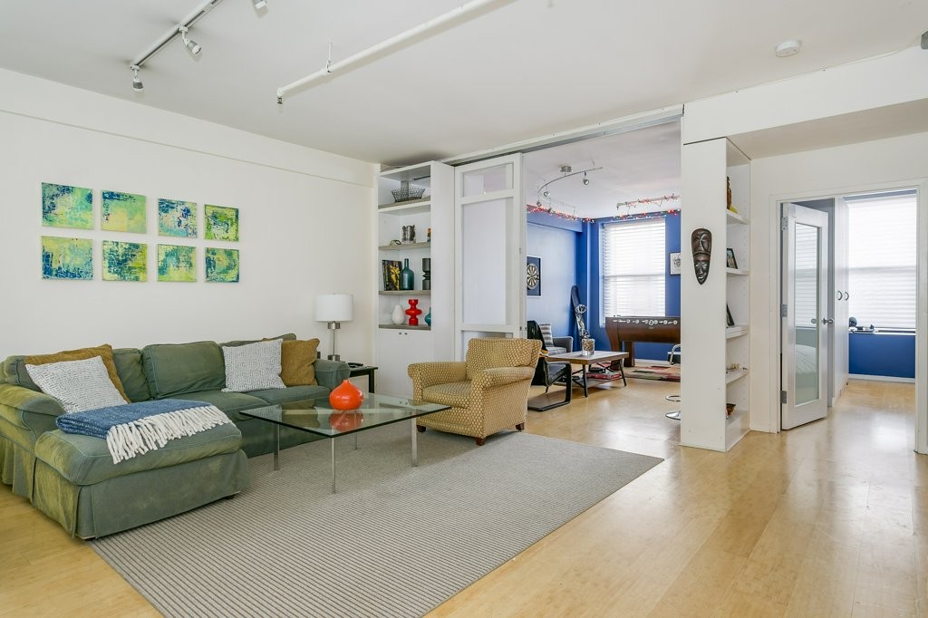 453 Washington Street, Unit 5D Boston, MA 02111 - Photo 1 of 17 a living room with furniture and a large window