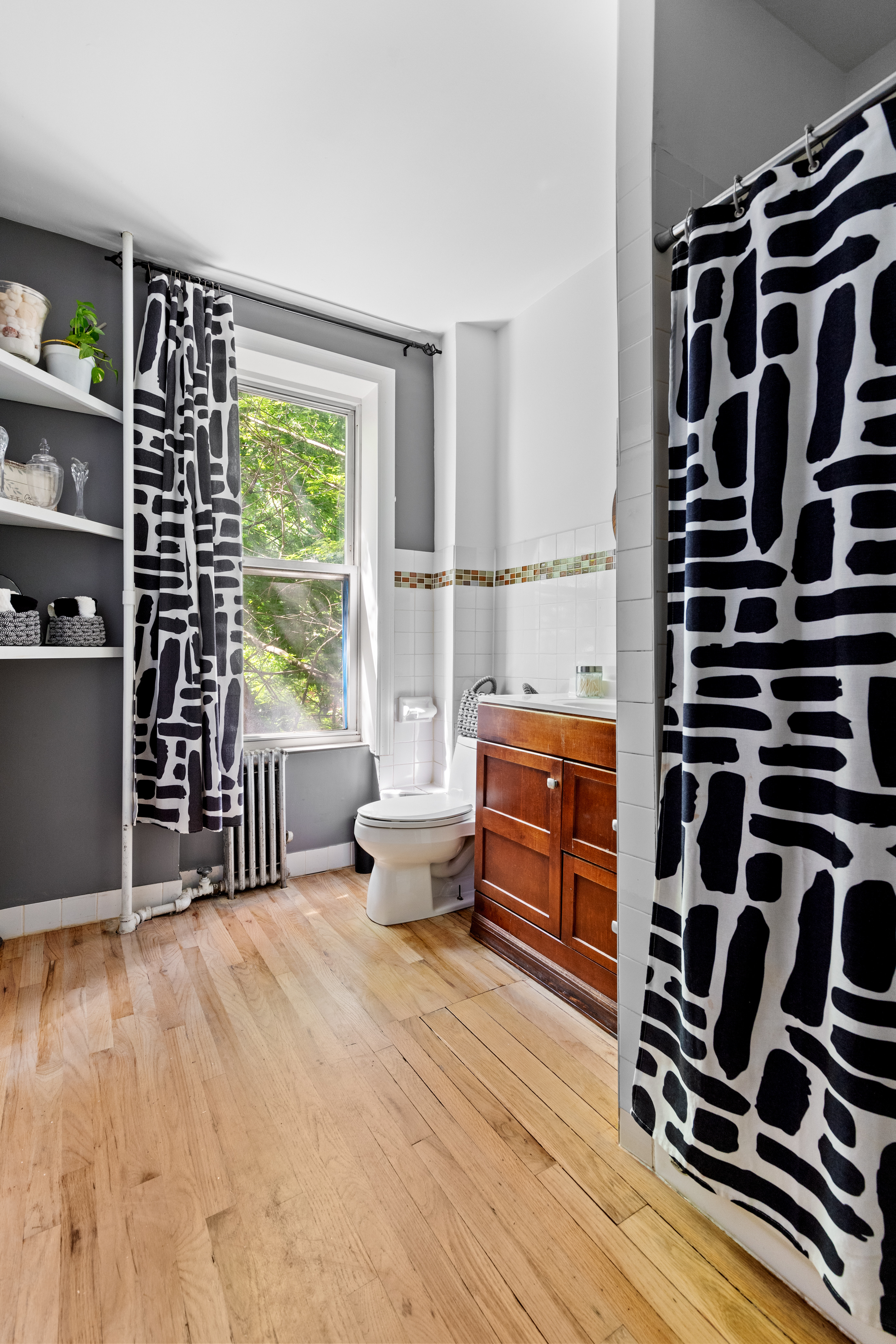 300 Gates Avenue Brooklyn, NY 11216 - Photo 5 of 13 a bedroom with furniture and a window