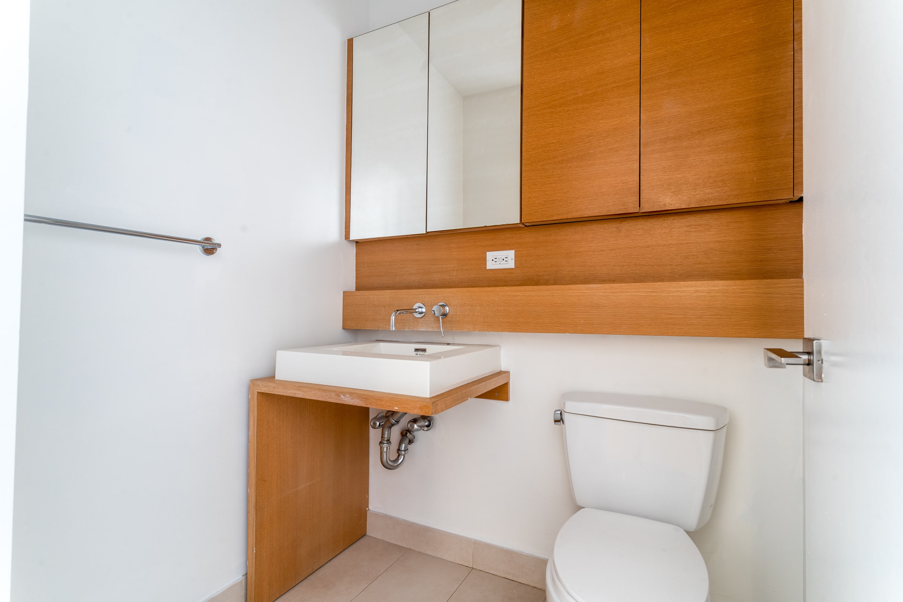 342 East 110th Street, Unit 3D Manhattan, NY 10029 - Photo 14 of 15 a bathroom with a toilet a sink and mirror