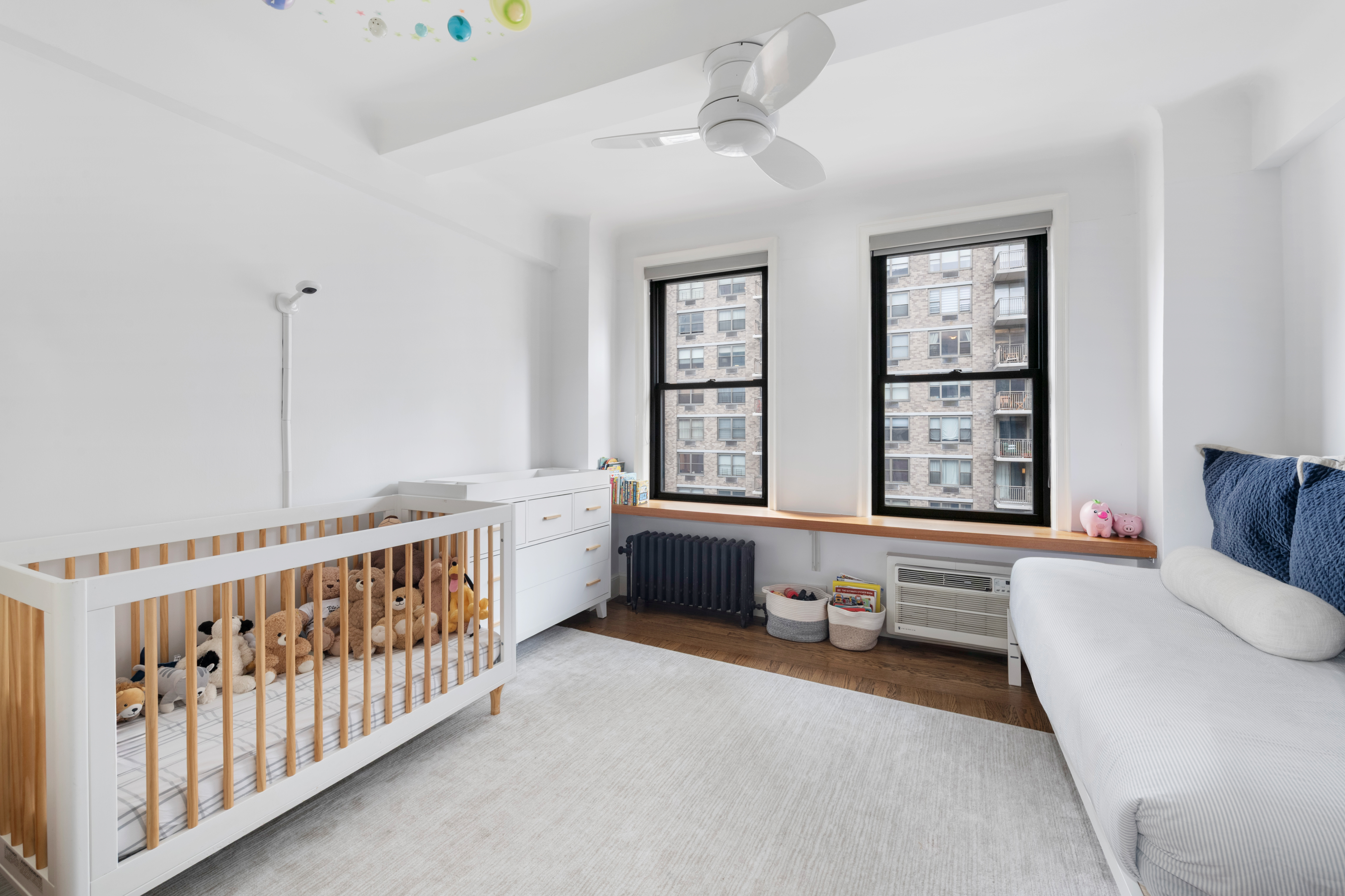 308 East 79th Street, Unit 13EF Manhattan, NY 10075 - Photo 9 of 16 a living room with furniture and windows