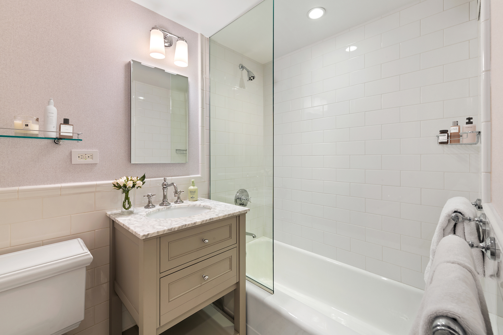 110 East 57th Street, Unit 10CD Manhattan, NY 10022 - Photo 13 of 16 a bathroom with a sink a toilet and shower