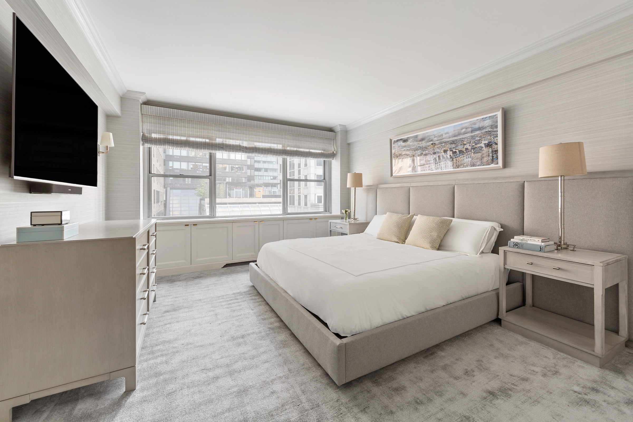 110 East 57th Street, Unit 10CD Manhattan, NY 10022 - Photo 8 of 16 a spacious bedroom with a bed and a flat screen tv