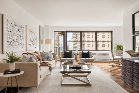 a living room with furniture large window and flat screen tv