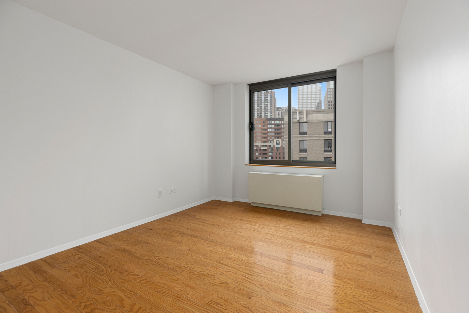 2 South End Avenue, Unit 8E Manhattan, NY 10280 - Photo 6 of 16 an empty room with a empty space and windows