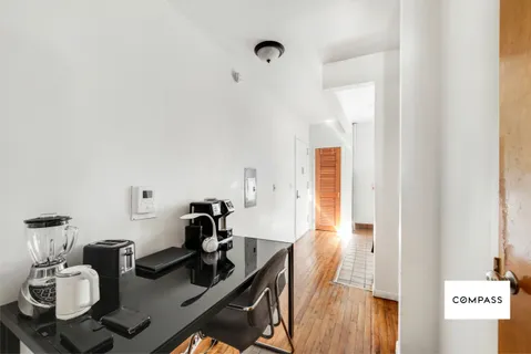 a view of a workspace with furniture and wooden floor