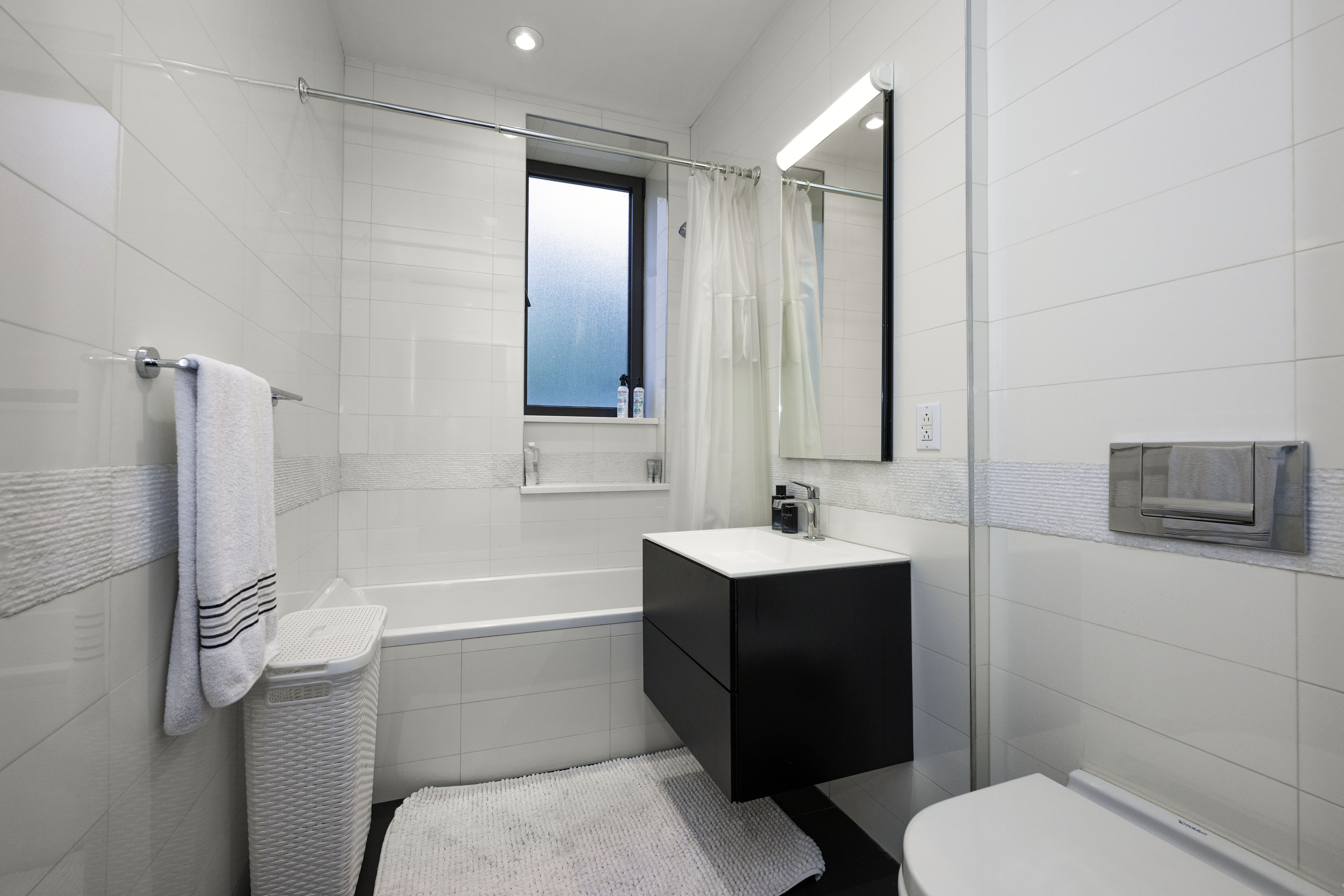 40 East 62nd Street, Unit 8E Manhattan, NY 10065 - Photo 18 of 24 a bathroom with a sink toilet and shower