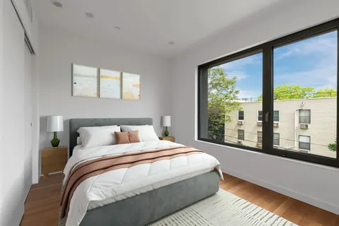 a bedroom with a large bed and a large window