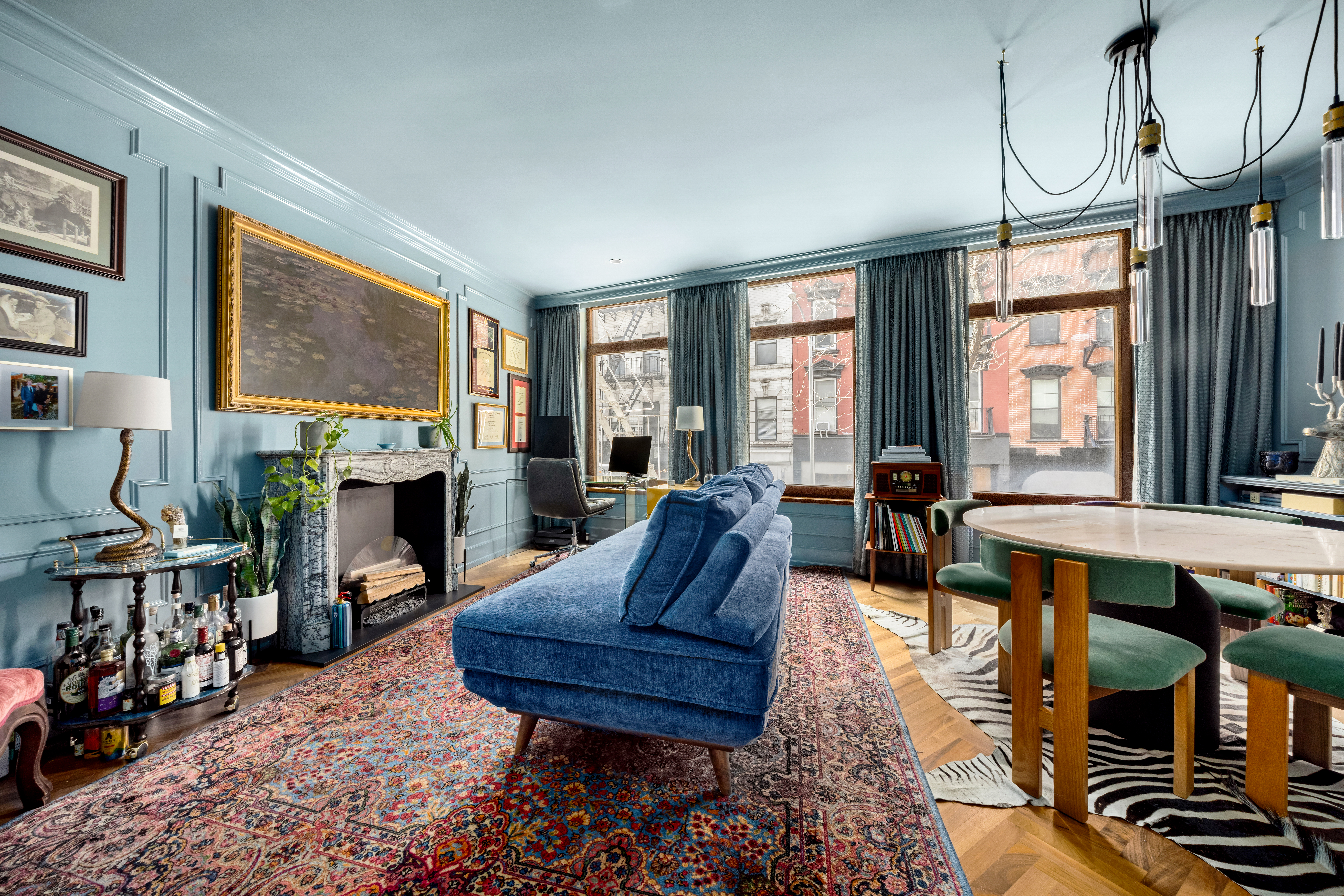a living room with furniture a fireplace and windows