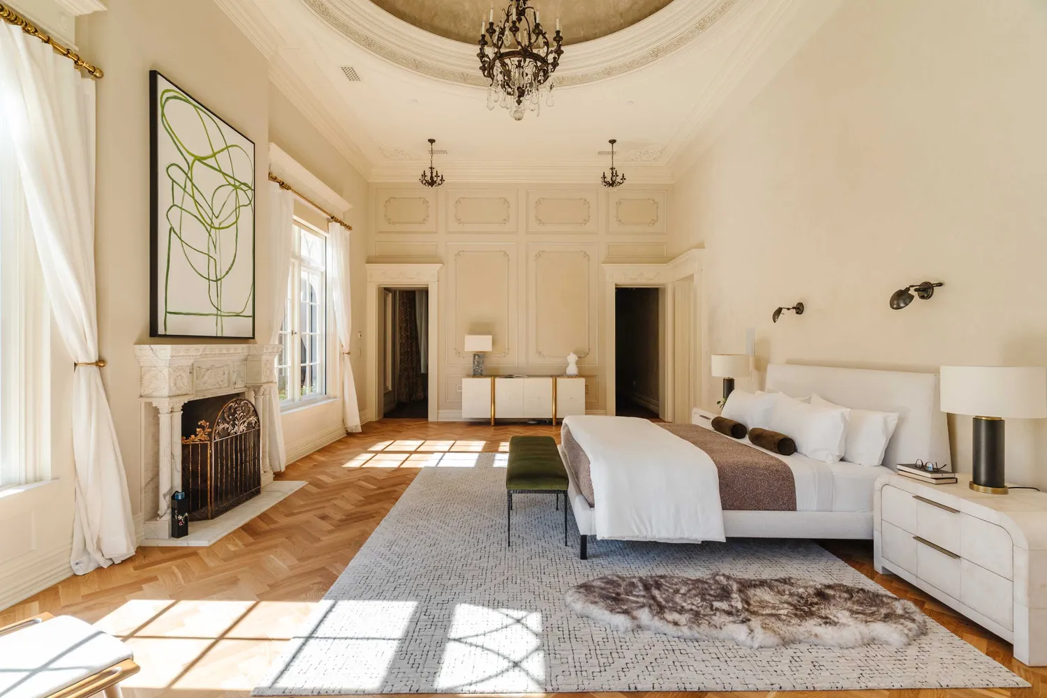 a spacious bedroom with a large bed and a fireplace