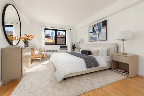 a spacious bedroom with bed and a window