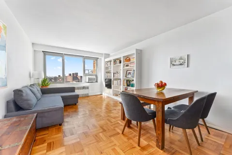 a view of dining room and livingroom with furniture wooden floor and a rug