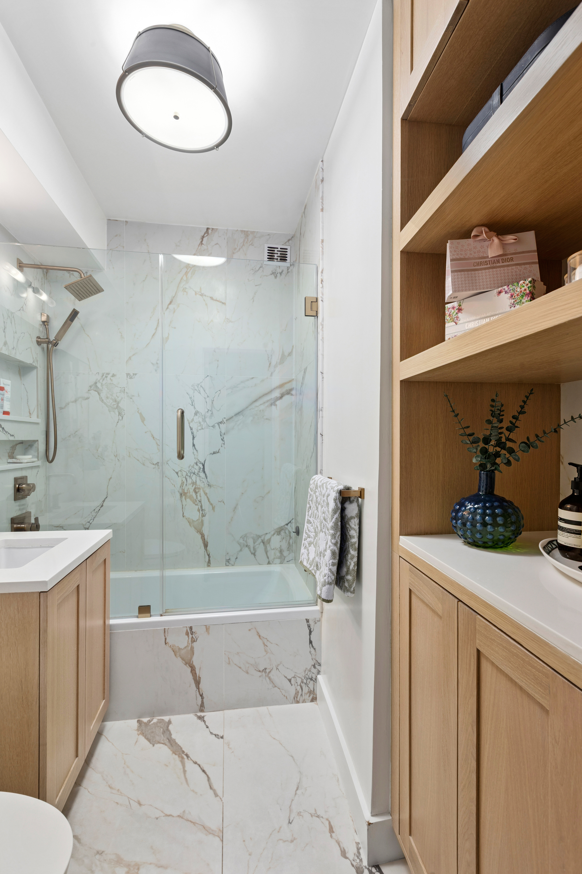 40 East 9th Street, Unit 7L Manhattan, NY 10003 - Photo 10 of 17 a bathroom with a sink a toilet and shower