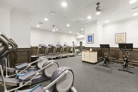 a living room with furniture and floor to ceiling window