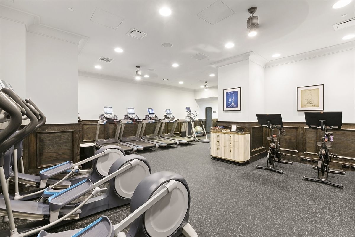 121 Nassau Street, Unit 17A Manhattan, NY 10038 - Photo 12 of 19 a living room with furniture and a flat screen tv