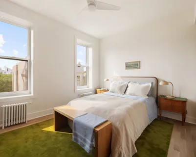 a bedroom with a bed and a window