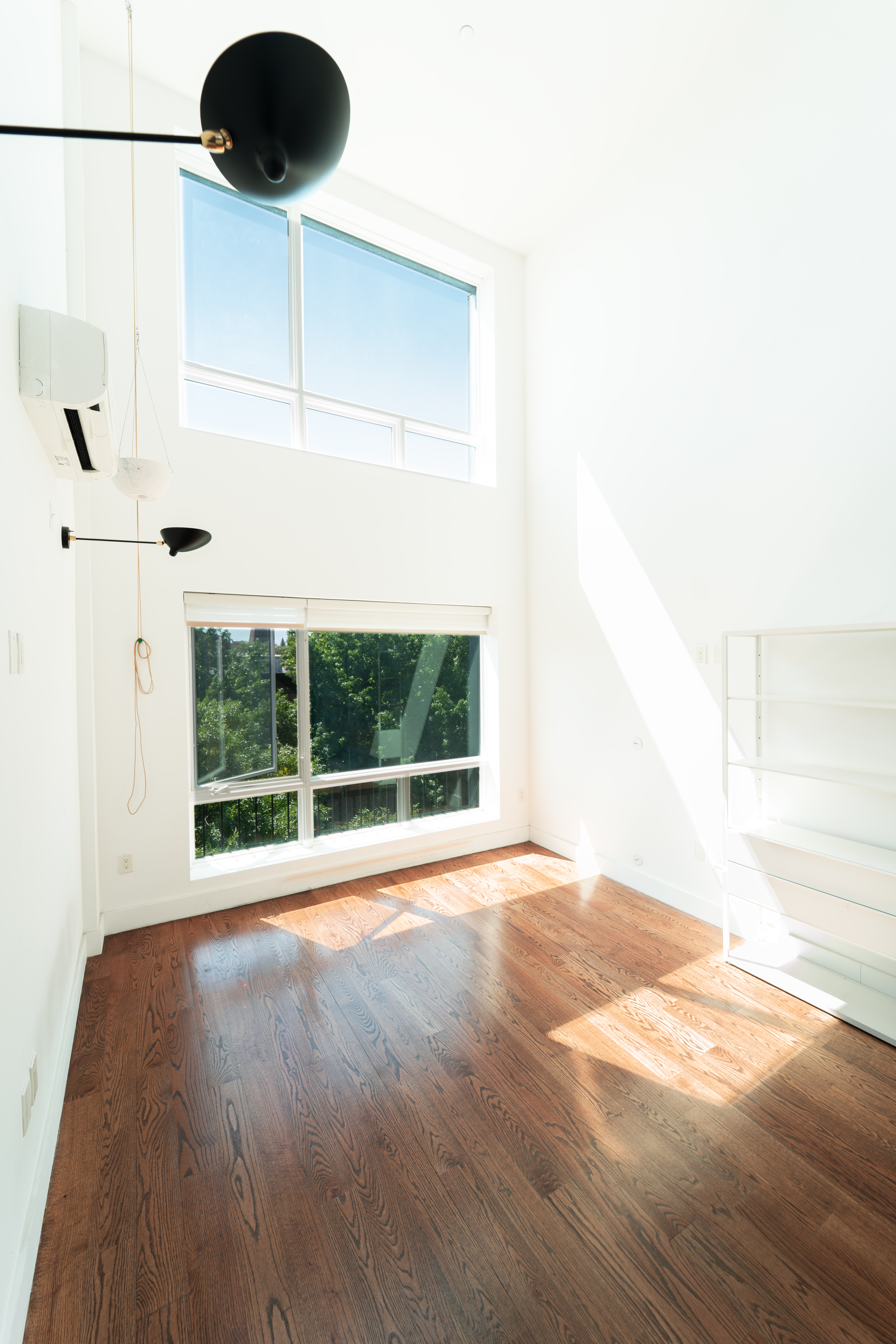 299 Van Buren Street, Unit 4C Brooklyn, NY 11221 - Photo 6 of 16 a view of an empty room with a window and wooden floor
