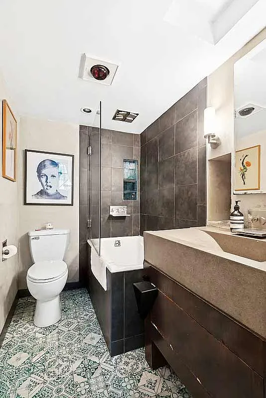 300 East 4th Street, Unit 1A Manhattan, NY 10009 - Photo 5 of 10 a bathroom with a sink a toilet and shower