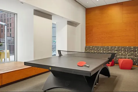 a view of a room with pool table and a window
