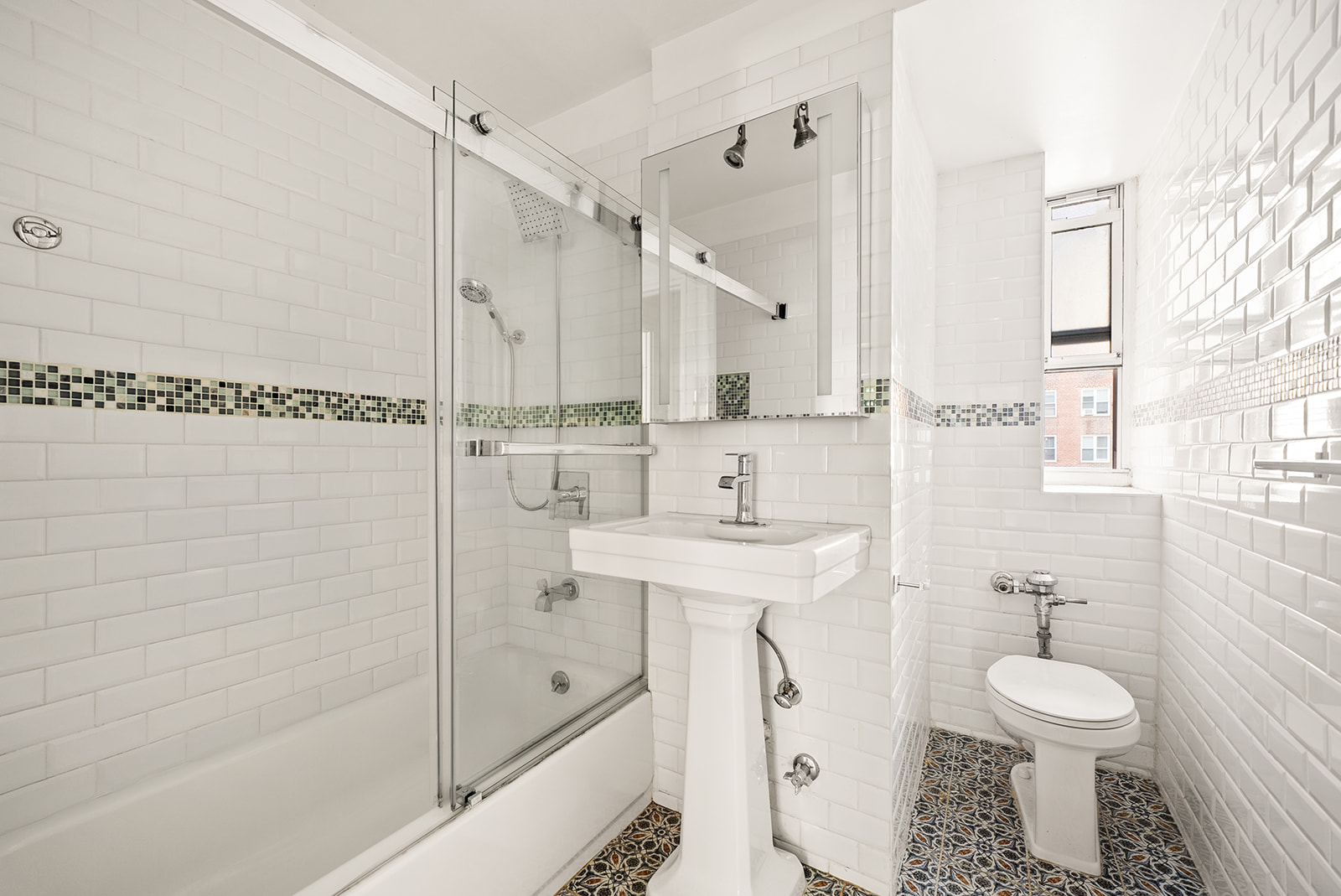 33-26 82nd Street, Unit 1H Queens, NY 11372 - Photo 6 of 11 a bathroom with a sink a toilet and shower