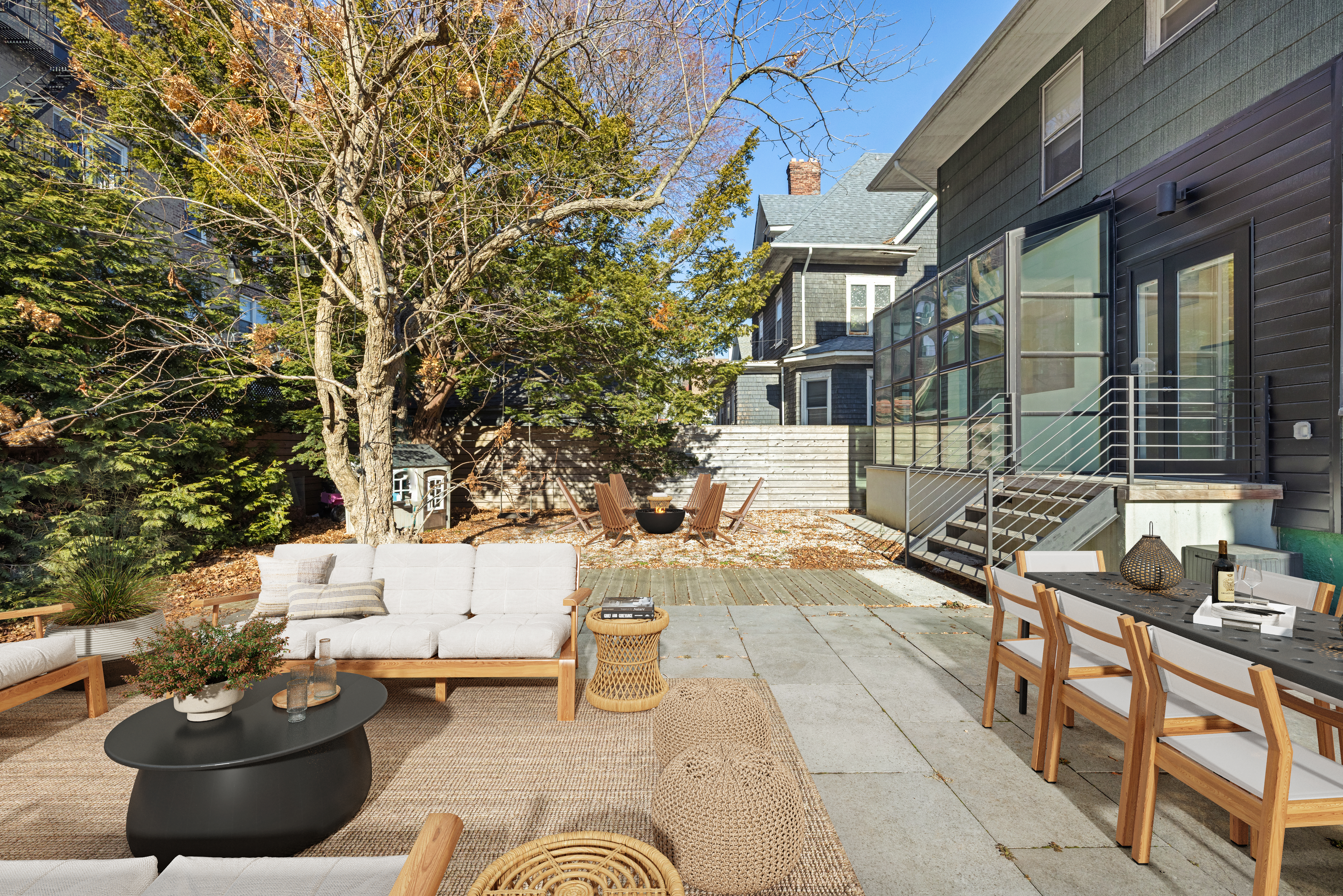 792 East 21st Street Brooklyn, NY 11210 - Photo 27 of 29 a view of a patio with table and chairs potted plants and large tree