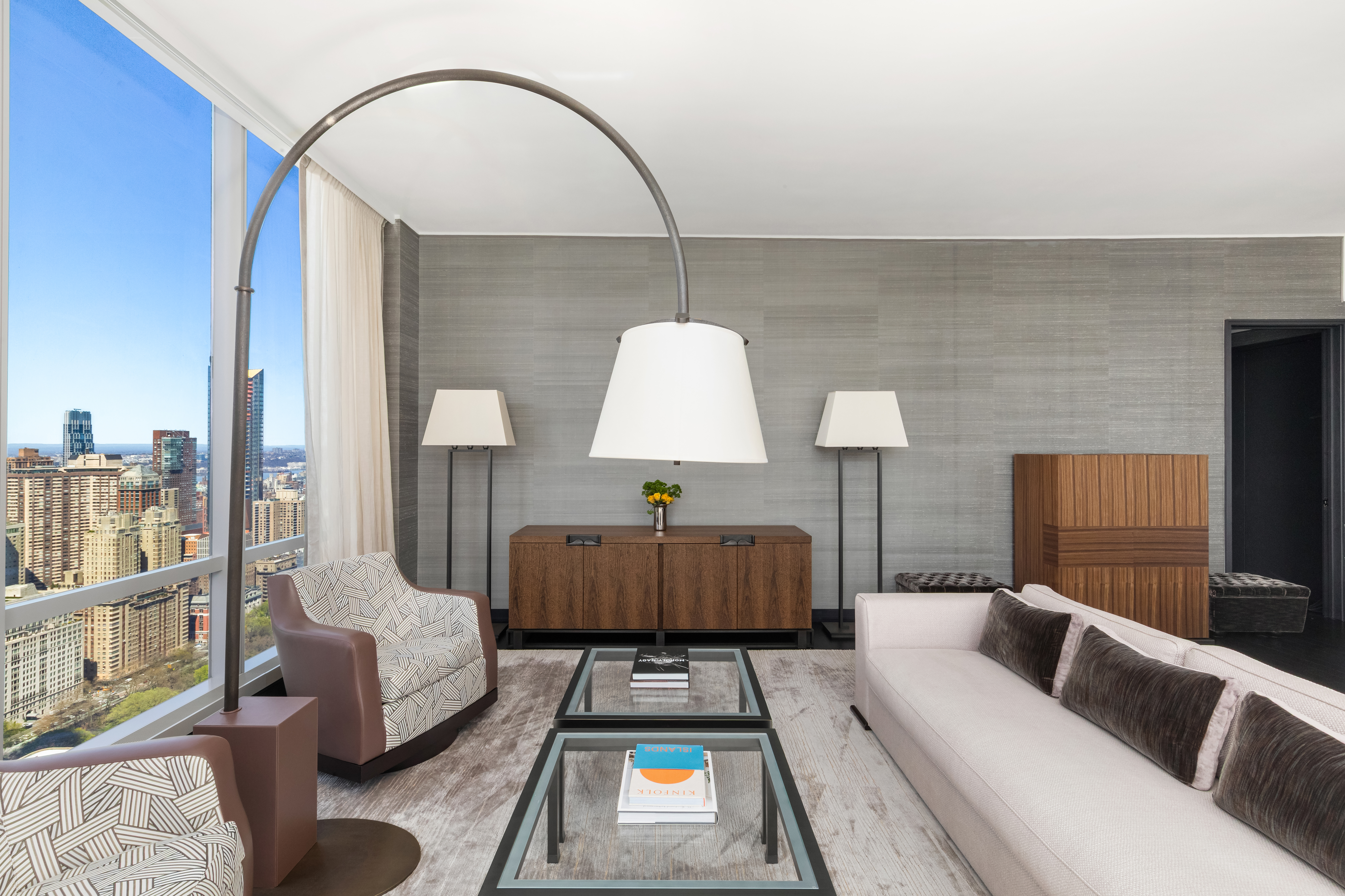 157 West 57th Street, Unit 50B Manhattan, NY 10019 - Photo 5 of 18 a living room with furniture and a wooden floor