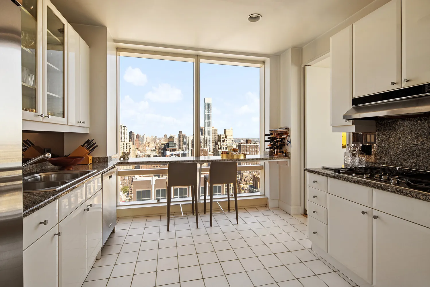a kitchen with granite countertop appliances cabinets and furniture