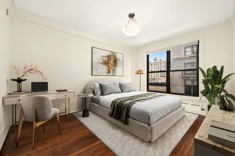 a bedroom with a large bed and a table