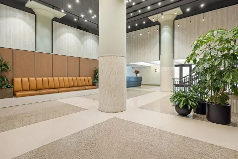 a view of a garden with a building in the background