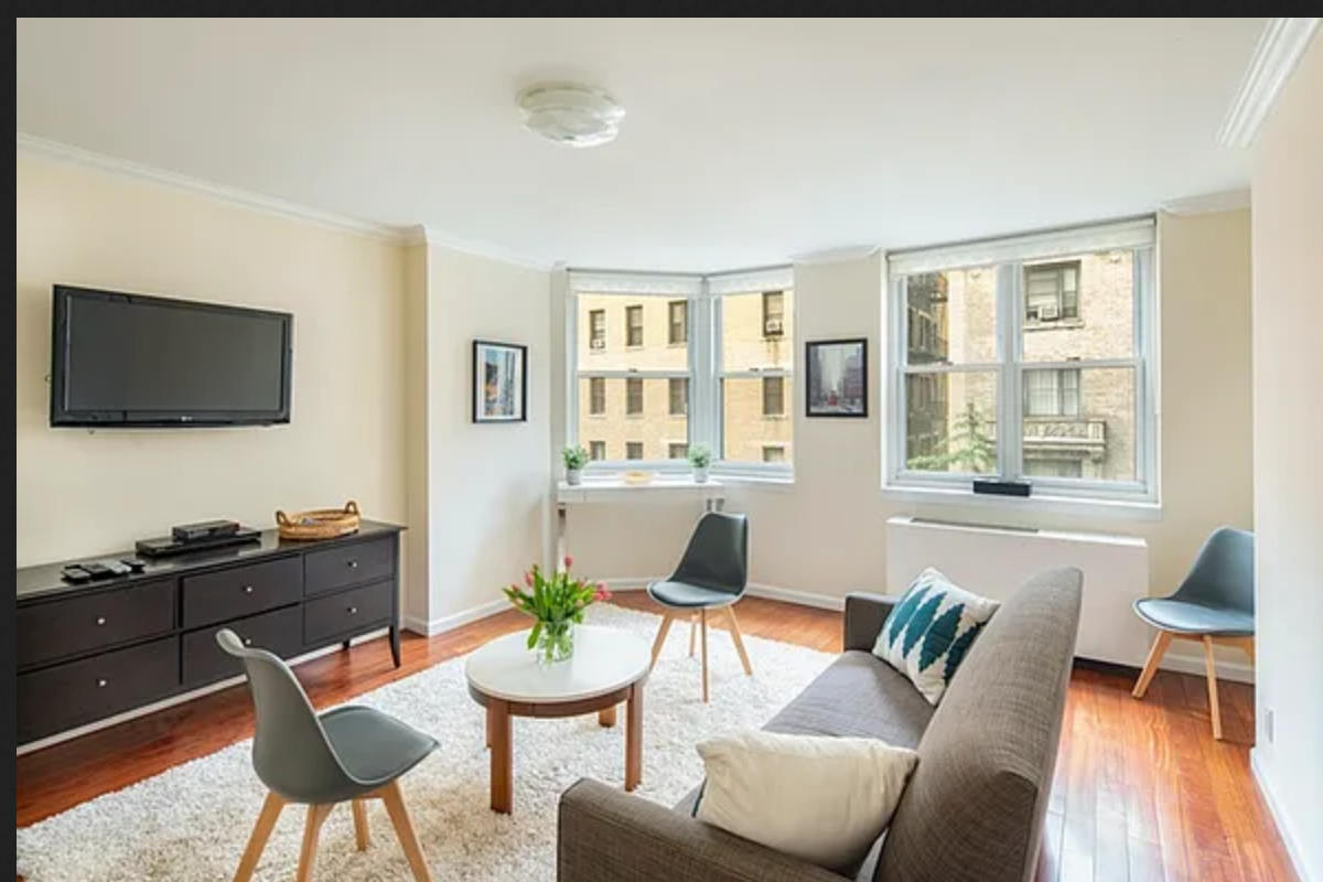 255 West 85th Street, Unit 7A Manhattan, NY 10024 - Photo 3 of 7 a living room with furniture and a flat screen tv