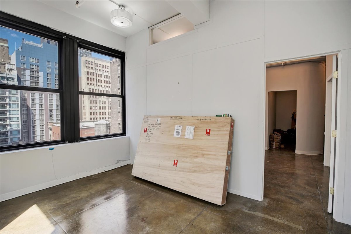 146 West 29th Street, Unit 9W Manhattan, NY 10001 - Photo 8 of 10 a view of an empty room with a window