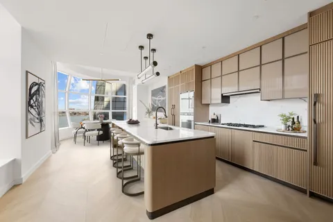 a kitchen with stainless steel appliances granite countertop a sink and cabinets