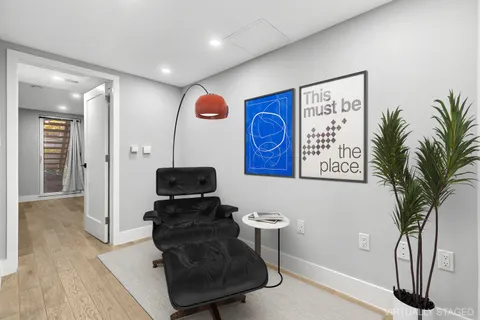 a living room with furniture and a potted plant