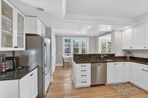 a kitchen with stainless steel appliances granite countertop a sink stove and refrigerator