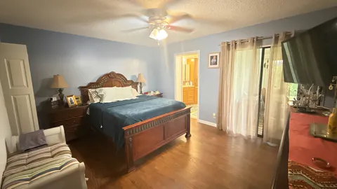 a living room with stainless steel appliances granite countertop furniture and a flat screen tv