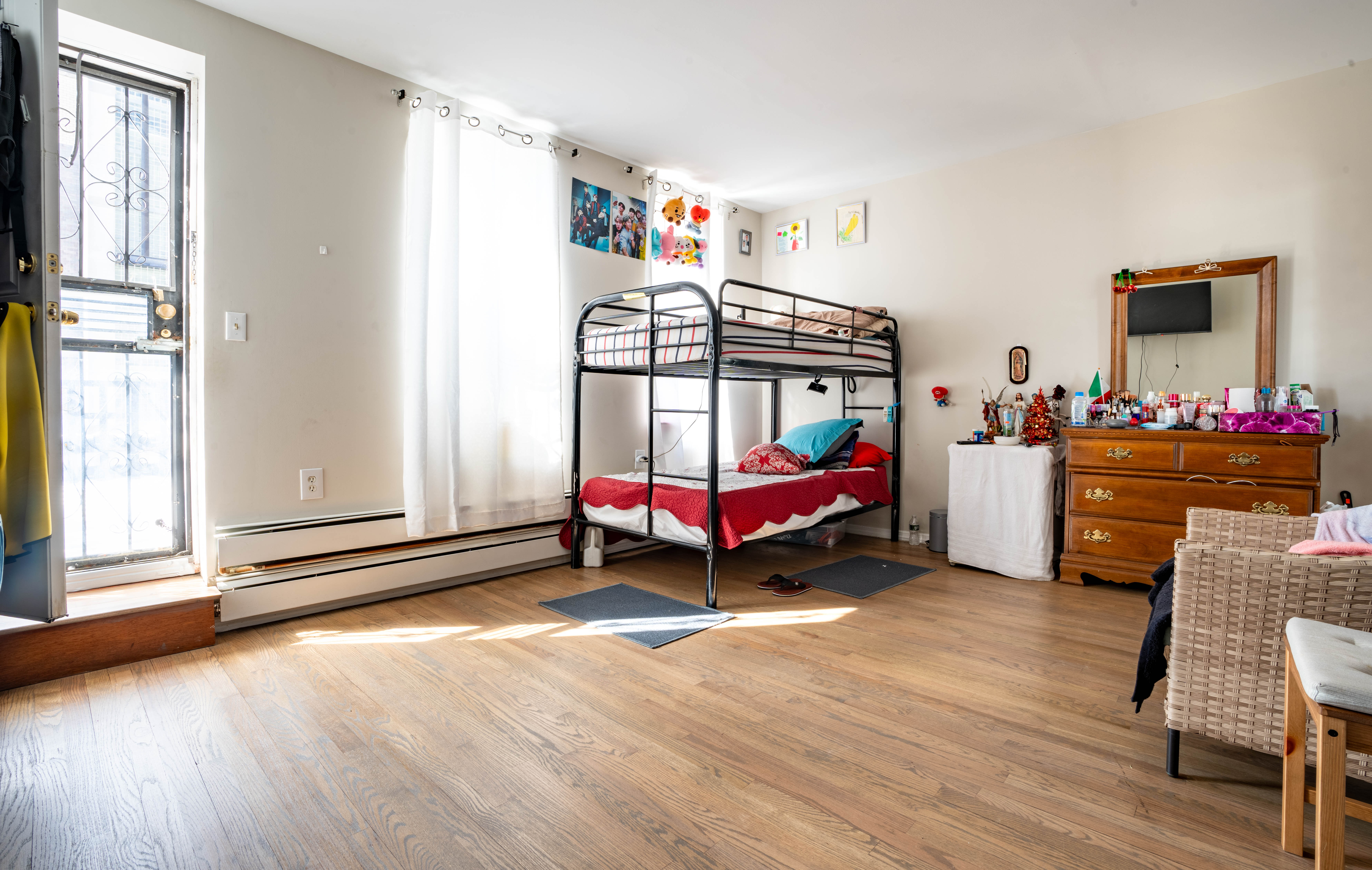 936 Seneca Avenue Queens, NY 11385 - Photo 7 of 12 a living room with furniture and a baby crib