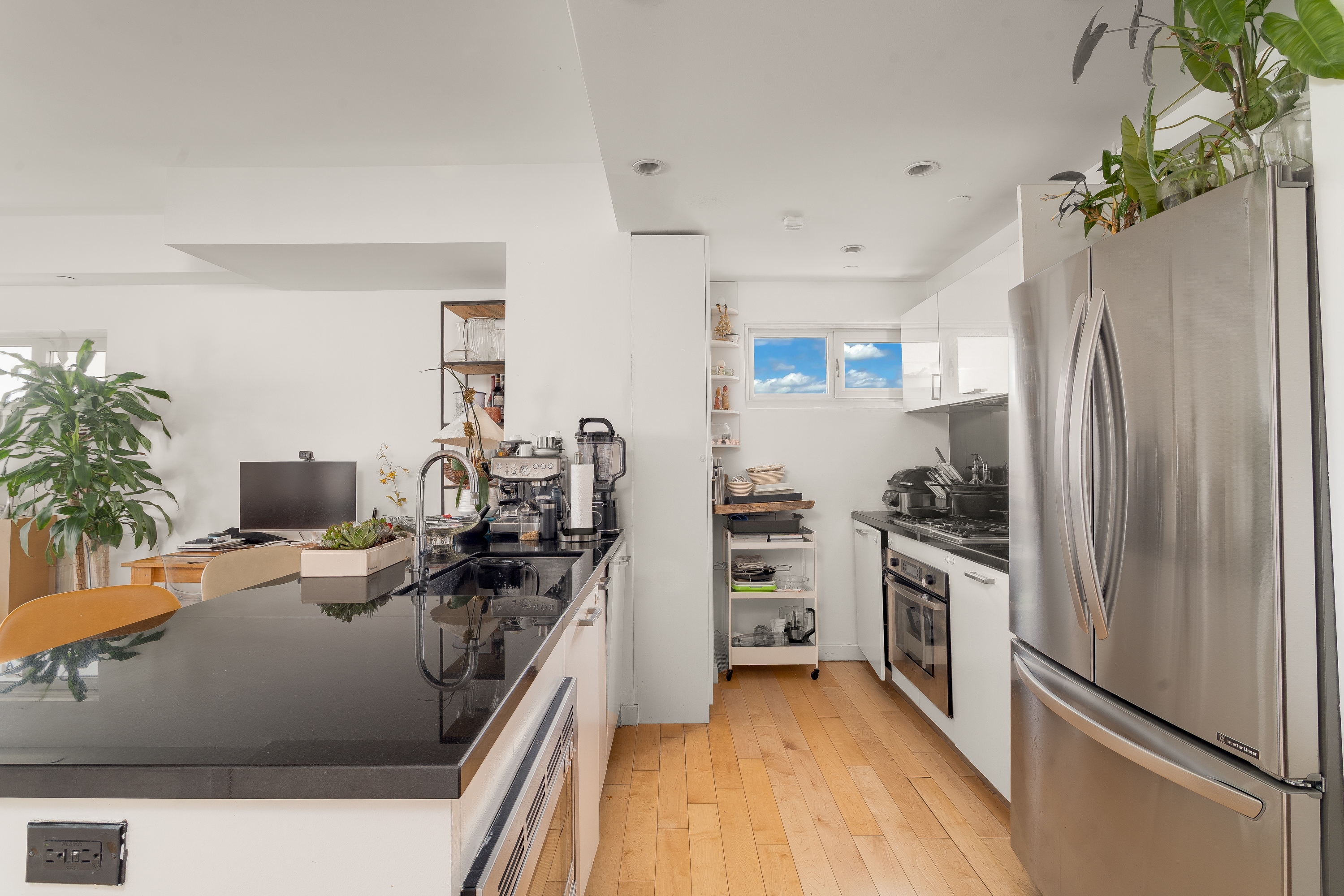560 Carroll Street, Unit 11A Brooklyn, NY 11215 - Photo 3 of 15 a kitchen with stainless steel appliances granite countertop a refrigerator a stove and a wooden floors