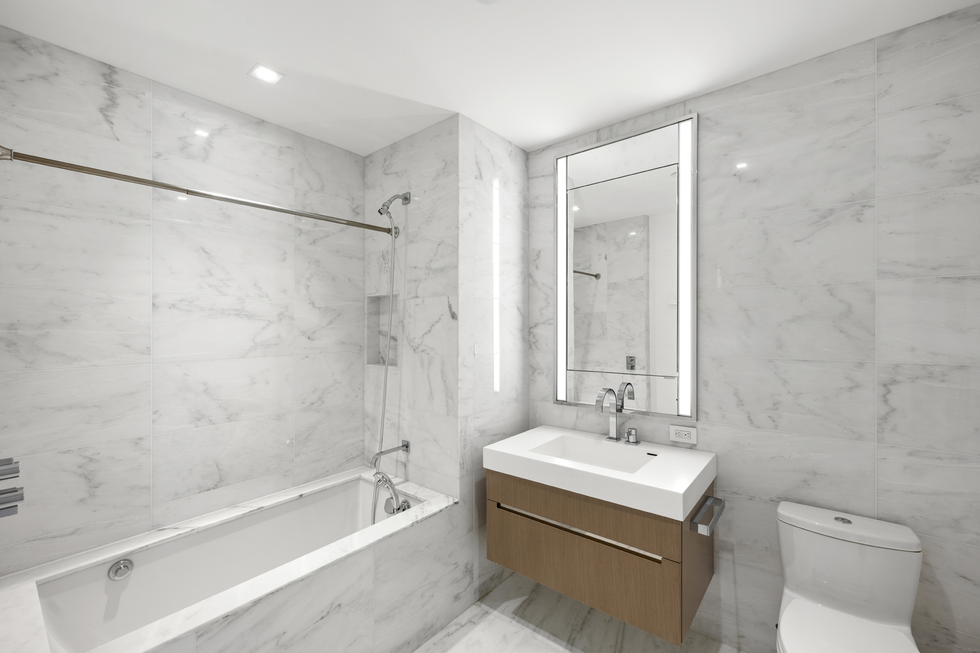 1 West End Avenue, Unit 22C Manhattan, NY 10023 - Photo 11 of 15 a bathroom with a sink a toilet and shower