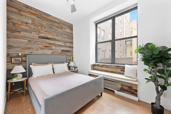a spacious bedroom with a bed and a large window