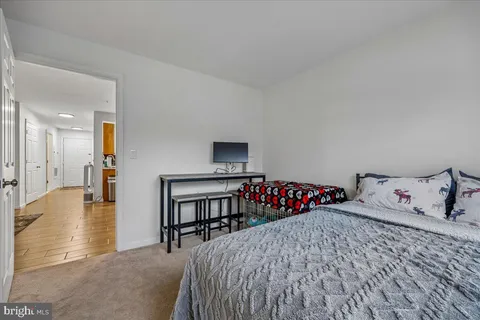 a bedroom with a bed and a lamp