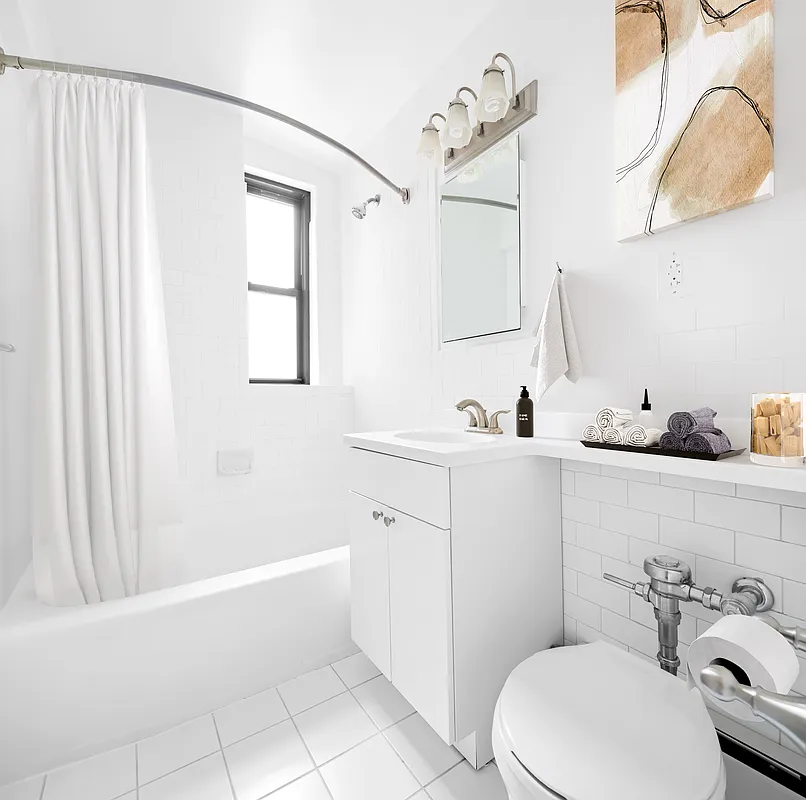85 4th Avenue, Unit 2LL Manhattan, NY 10003 - Photo 3 of 7 a bathroom with a sink a toilet and shower